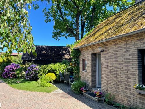 a brick house with a patio and flowers at Ferienwohnung im Rauchwinkel in Hösseringen