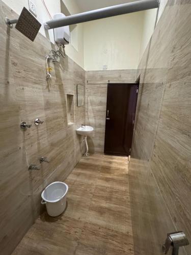 a bathroom with a toilet and a sink at Golden Waves Guest House in Mahabalipuram