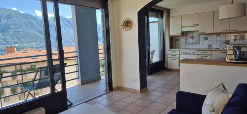 a kitchen with a view of a mountain at Hotel Barca Blu in Orselina