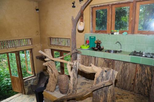 a kitchen with a counter and a sink in a room at Achinthya Nature Resort in Avissawella