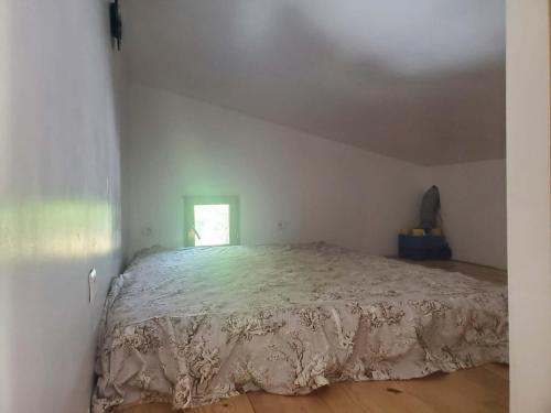a bedroom with a large bed in a attic at Tranquillité in Le Cheylard