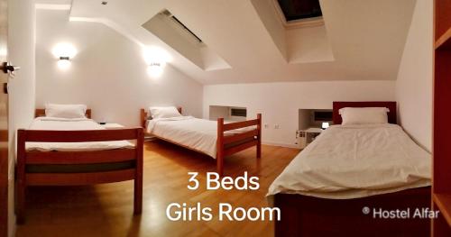 a bedroom with two beds and a girls room at Hostel Alfar in Sarajevo