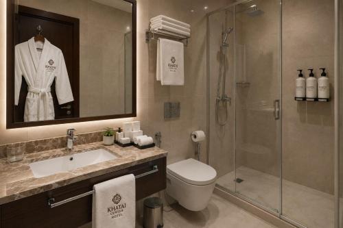 a bathroom with a toilet sink and a shower at Khatai Center Hotel in Baku