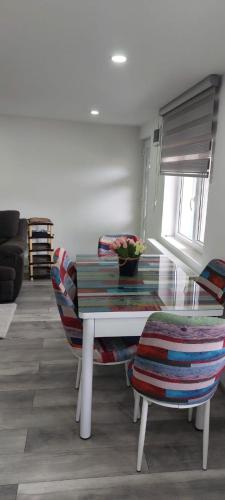 a living room with a table and some chairs at Casa ALBERT in Brezoi