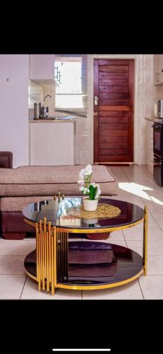 a living room with a coffee table and a couch at ShanazNest in Bulawayo