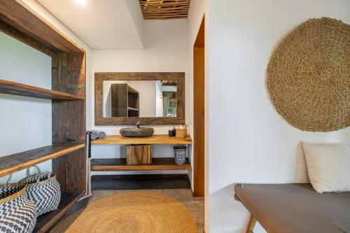 a bathroom with a sink and a mirror at La Reserva Villas Bali in Jimbaran