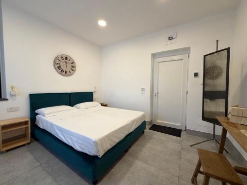 a bedroom with a bed and a clock on the wall at RIAMA AGRIRESORT in Naples