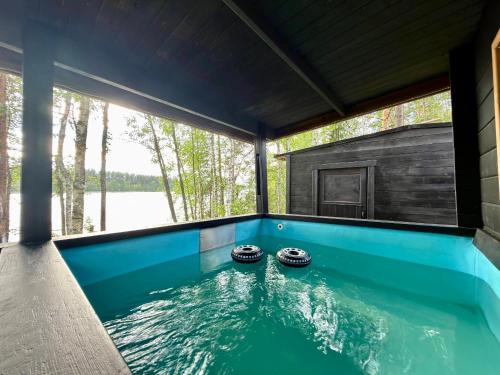 a swimming pool in a house at Tree Tents Camping Linnansaari in Savonlinna