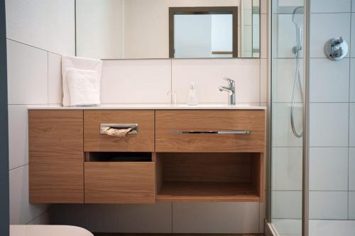 a bathroom with a sink and a shower at Flair Hotel Grüner Baum in Donaueschingen