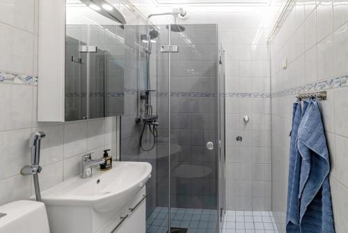 a bathroom with a shower and a sink at 3 bedrooms house with garden in Rauma