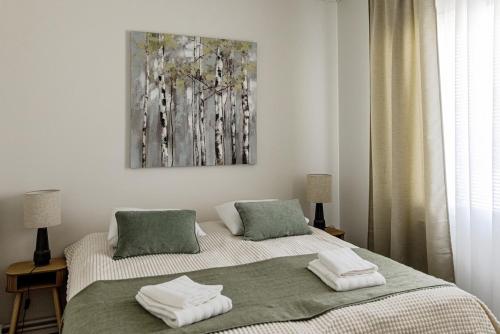 a bedroom with a bed with two towels on it at 3 bedrooms house with garden in Rauma