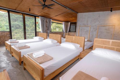 four beds in a room with windows at Hillcrest Dawn, Bentong in Bentong