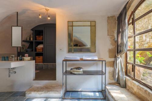 a bathroom with a sink and a mirror at Le Mas D'alzon in Vagnas