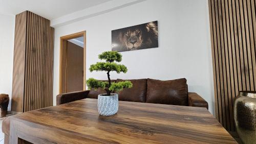 a living room with a wooden table with a plant on it at Fewo-OPR de Billi in Wusterhausen