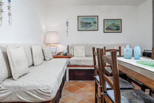 a living room with a couch and a table at Brezza Smeralda- Costa Smeralda in Cala Bitta
