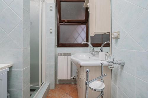 a bathroom with a sink and a mirror at Brezza Smeralda- Costa Smeralda in Cala Bitta