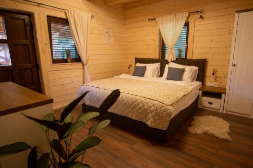 a bedroom with a bed in a wooden room at Macaklin Fužine in Fužine