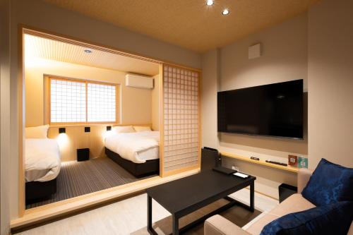 a hotel room with a bedroom with a large mirror at 別府 夕凪 in Beppu