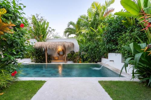 a swimming pool in the backyard of a villa at Villa Ruta II - Luxury 2BR Tropical Villa next to Luna Beach Club and Nyanyi beach in Tanah Lot
