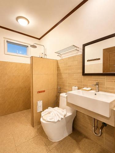 a bathroom with a toilet and a sink at ClayHouse SAMUI Boutique Hotel in Koh Samui