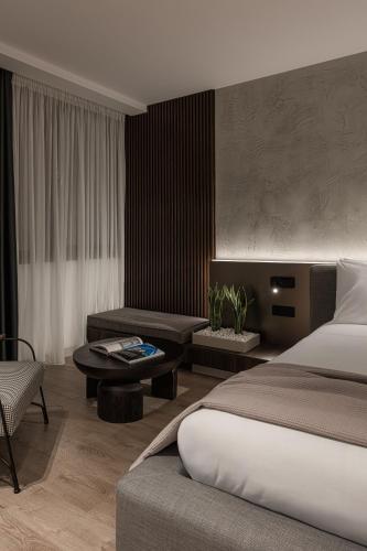 a bedroom with a bed and a living room at Union43 Ioannina in Ioannina