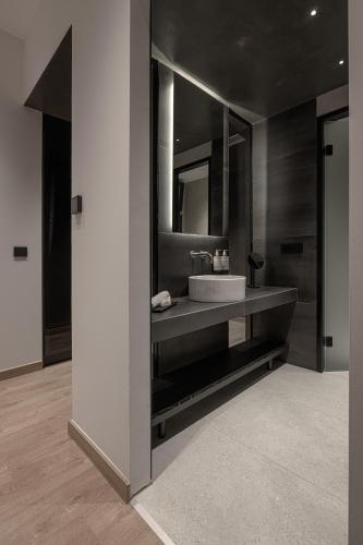 a bathroom with a sink and a mirror at Union43 Ioannina in Ioannina