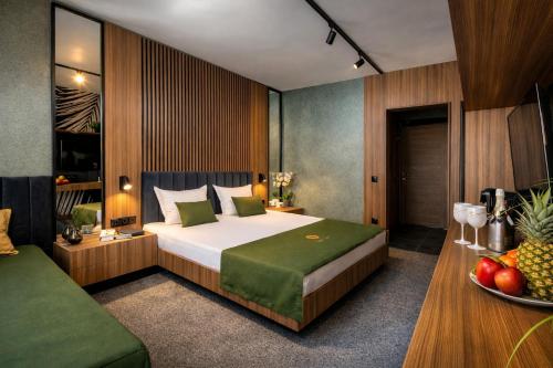 a bedroom with a bed and a bowl of fruit at Hotel Palms Beach Kiten in Kiten