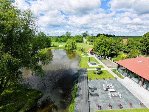 an aerial view of a river with tables and chairs at Słoneczny Ogród - Ekskluzywna posiadłość nad wodą, Grill i Jacuzzi in Krzywińskie
