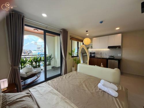 a bedroom with a bed and a view of a kitchen at Cưng Homestay SG in Ho Chi Minh City