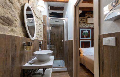 a small bathroom with a sink and a shower at La Casetta nel Borgo in Montalbano Elicona