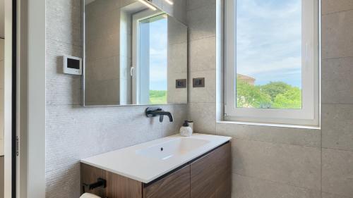 a bathroom with a sink and a mirror at Villa Moia by Villas Guide in Kaštelir