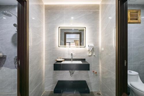 a bathroom with a sink and a mirror at Sunset Mountain View Resort in Vang Vieng