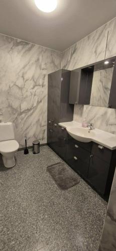 a bathroom with a sink and a toilet at The Yellow House in Boden