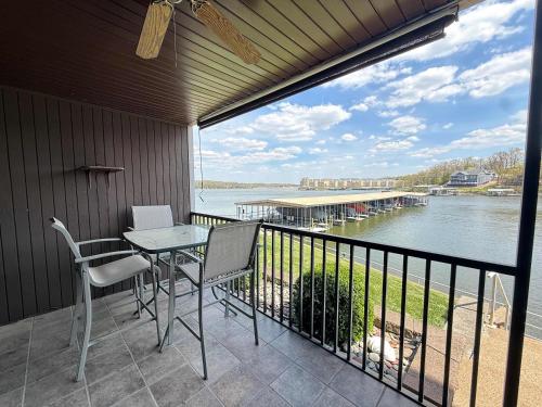 a balcony with a table and chairs and a view of the water at LOTO fun at 21 Lakeview Condo in Osage Beach