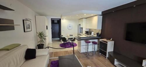 a living room with a couch and a kitchen at Apartman Jo Ma MA in Solin