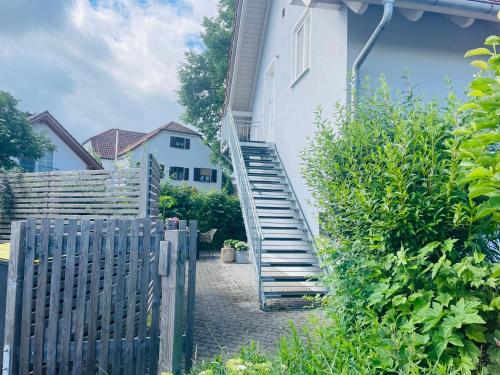 a stairway leading up to a white house at Appartement Morgensonne in Egling