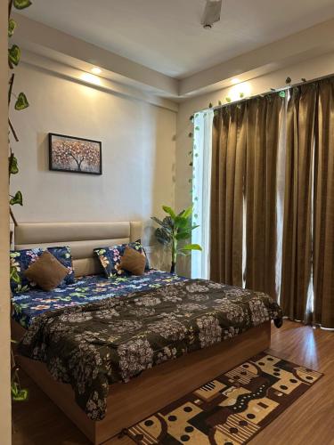 a bedroom with a bed and a window at Comfort Corner in Greater Noida
