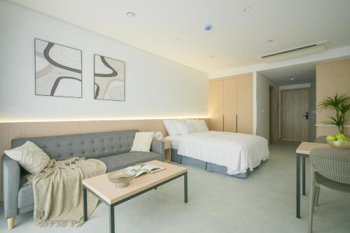 a hotel room with a couch and a bed at TS Apartment in Hanoi