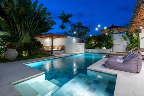 a swimming pool in the backyard of a house at Villa Ruta I - Sumptuous 2BR Luxury Villa next to Luna Beach Club and Nyanyi Beach in Tanah Lot