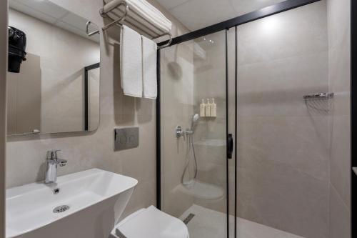 a bathroom with a shower and a toilet and a sink at Mesona Hotels Blue Hill in Antalya