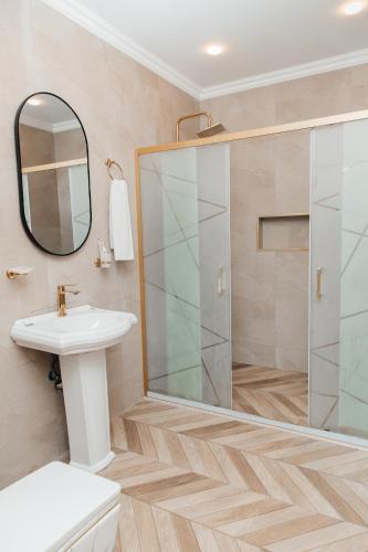 a bathroom with a shower and a toilet and a sink at Ganja Hotel in Ganja
