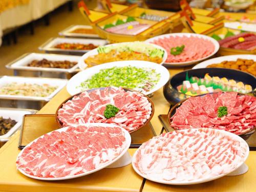 a table with many plates of food on it at Hotel Kirishima Castle in Kirishima