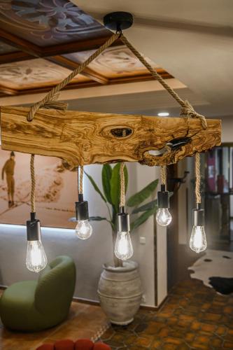 a chandelier with lights hanging from a ceiling at Hotel Völserhof - Bergbahn im Sommer 2026 inklusive in Bad Hofgastein