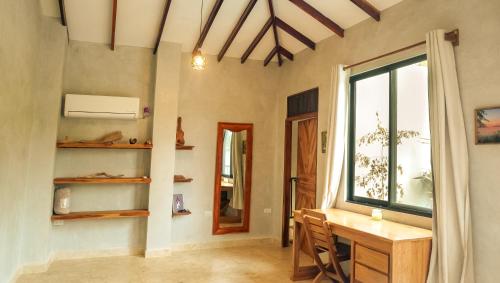 a home office with a desk and a window at Mystic Beach Resort in Guachaca