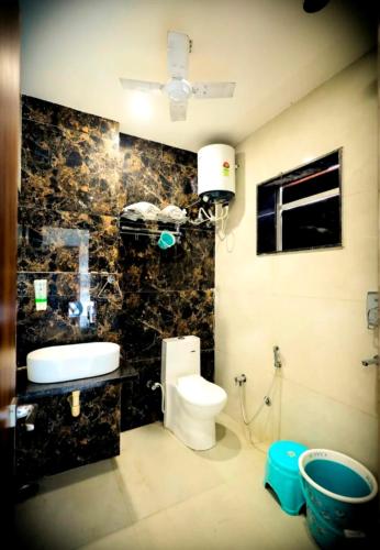 a bathroom with a toilet and a sink at G N Hotel & Restaurant Bodla in Agra