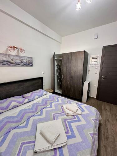 a bedroom with a bed with two napkins on it at Kova2 in Alexandroupoli
