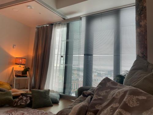 a living room with a large window and a couch at 1 studio seaview kalasatama Helsinki in Helsinki