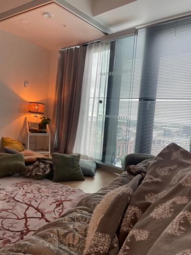 a bedroom with a bed and a large window at 1 studio seaview kalasatama Helsinki in Helsinki