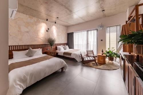 a hotel room with two beds and a table at ANZ Apartment in Tuy Hoa