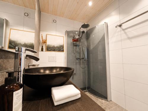 a bathroom with a bowl sink and a shower at Charming cabin with a view in Gol